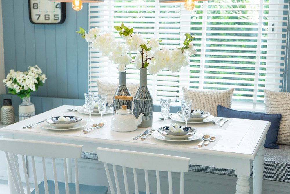 The "coastal grandmother" vibe has taken off in 2022. This kitchen reflects that style.