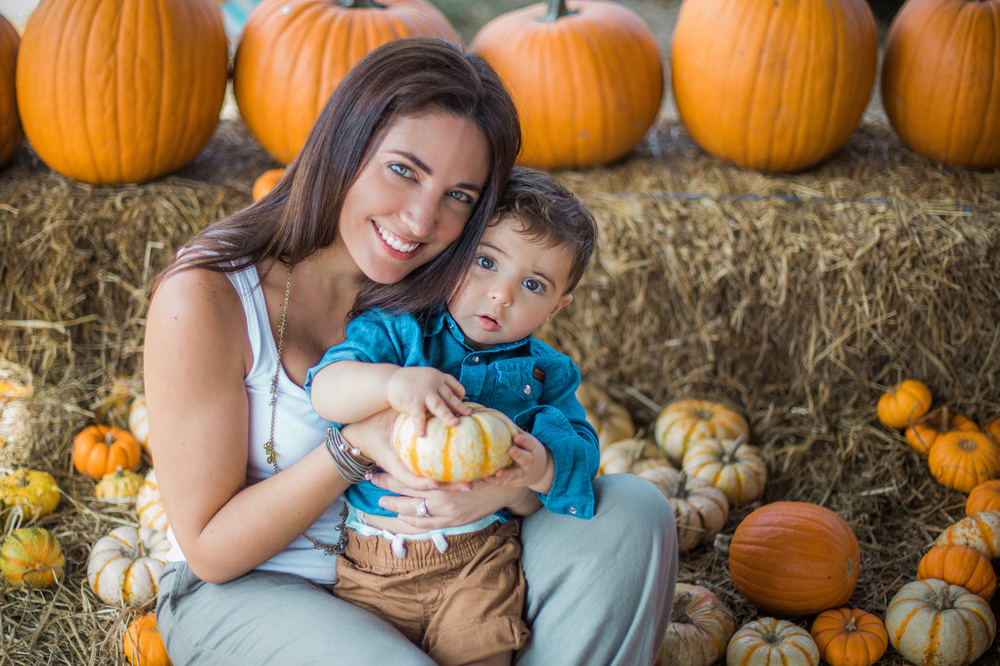 Mom and son picking a pumpkin in a pumpkin Patch in Florida
