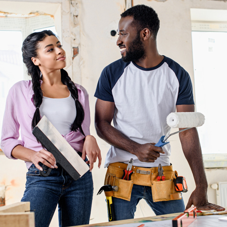 considerations when building vs buying a home attractive young couple making renovations to their home