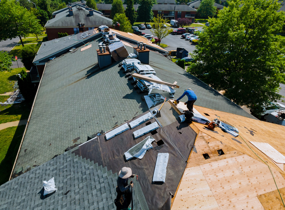 roof repairs on old home Construction worker on renovation roof the house installed new shingles