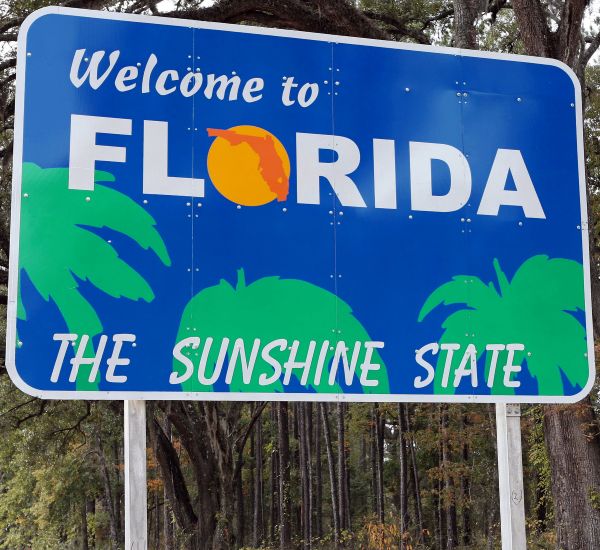 Welcome to Florida sign A blue sign that reads Welcome to Florida, The Sunshine State