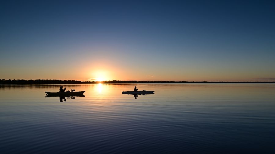 Two kayakers on calm water of Coot Bay